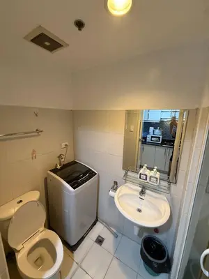 a bathroom with a toilet and a sink at Sea Residences Affordable Staycation Near MOA - by Rose in Manila
