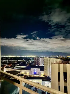 a view of a city at night from a building at 1BR Bahamas 19th floor, Azure Paraaque in Manila