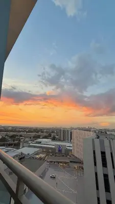 a view of a city at sunset from a building at 1BR Bahamas 19th floor, Azure Paraaque in Manila