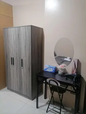 a desk with a mirror next to a wooden cabinet at Location perfect staycation with Netflix in Manila