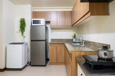 a kitchen with a refrigerator and a sink at 2 bed room in Fairlane Residences Pasig in Manila