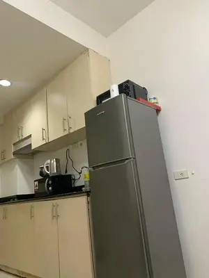a kitchen with a refrigerator in the corner at Sea Residences by Estelle in Manila