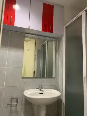 a bathroom with a sink and a mirror at Sea Residences by Estelle in Manila