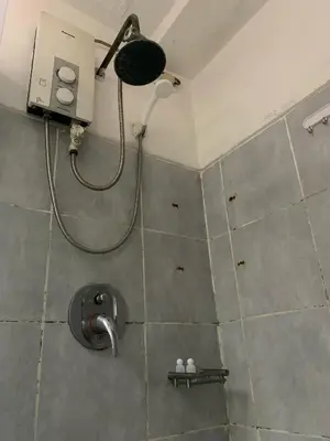 a bathroom with a shower with a shower head at Sea Residences by Estelle in Manila