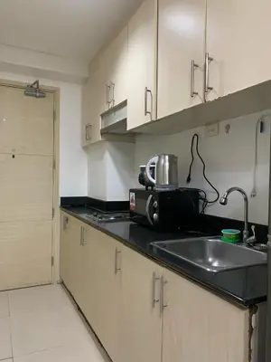 a kitchen with a sink and a toaster on the counter at Sea Residences by Estelle in Manila