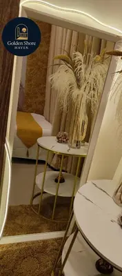 a room with a table and a chair and a table at Golden Shore Haven - Pasay in Manila