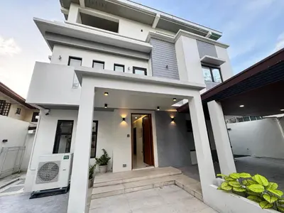 a modern house with a white facade at Halika Villa & Capitolo events place near BGC in Manila