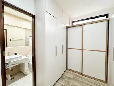 a bathroom with a sliding door and a sink at Halika Villa & Capitolo events place near BGC in Manila