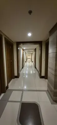 an empty hallway of a building with a hallwayngth at Rqui Condotel Rooms Near Airports and Newport World Casino in Manila