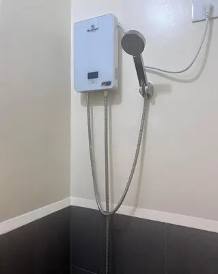 a shower in the corner of a bathroom at Mazal Residence in Manila