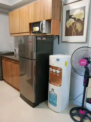 a kitchen with a refrigerator and a microwave at Sweet Condo in Manila