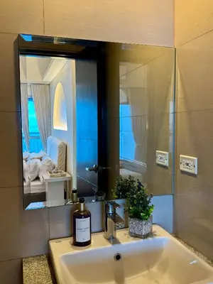 a bathroom with a sink and a mirror at Panoramic Seaview 2BR near Airport Facing the Bay 6G in Manila