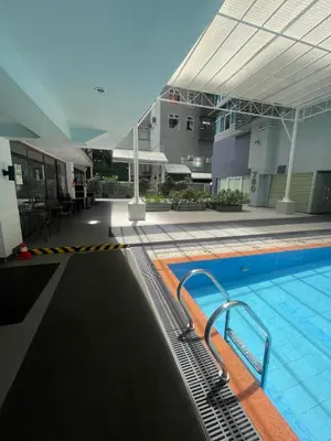 a large swimming pool in a building with a building at Antel Spa Residences 1908 in Manila