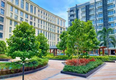 two trees in a courtyard in front of a building at Naia T3 Condotel in Manila