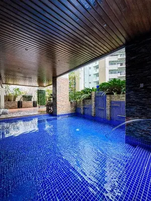 a large swimming pool with blue tiles in a building at Convertible Solo Budget Studio in Salcedo Village in Manila