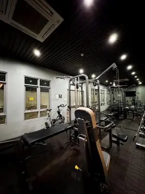 a gym with several treadmills and bikes in it at Convertible Solo Budget Studio in Salcedo Village in Manila