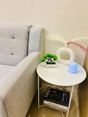 a living room with a couch and a table at 7 Mins from MOA Comfy Stay with Pool View and WiFi in Manila