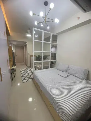 a bedroom with a bed and a ceiling fan at Field residences Building 9 in Manila