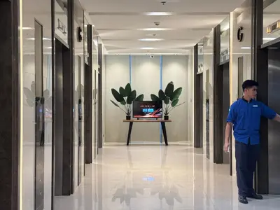 a man standing in the hallway of a building at SMDC Coast Residences Levi & Moon in Manila