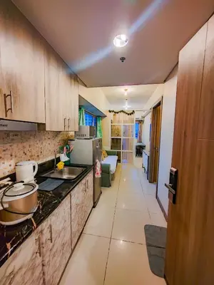 a kitchen with a sink and a counter top at SMDC Coast Residences Levi & Moon in Manila
