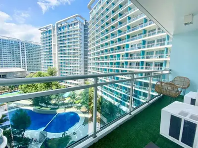 a balcony with a view of a large building at Leisure escape staycation Azure in Manila