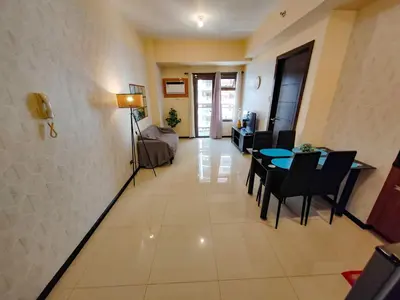 a living room with a table and a couch at Manila Bay View - 1BR with balcony in Manila