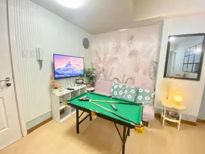 a room with a pool table and a desk at Leisure escape Azure staycation in Manila