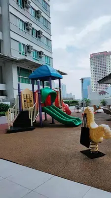 a playground with a slide and a play structure at The Catalina at The Beacon Makati in Manila