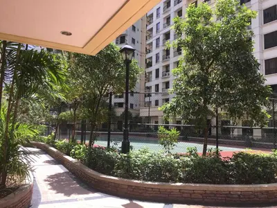 a courtyard in a building with trees and a street light at Rustic 1 BR Apartment Poolside View in Manila