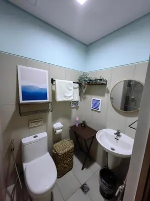 a bathroom with a toilet and a sink at Seaside Sanctuary and Beach Vibes in Manila