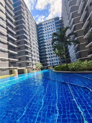 a swimming pool in front of some buildings at Aldo Staycation mall of Asia in Manila