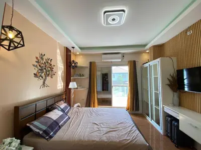 a bedroom with a bed and a tv on the wall at Casa MiKulai