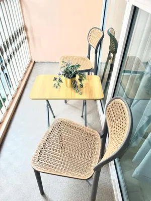 a table and chairs on a balcony with a plant at Classy Venice Grand Studio Balcony Pet friendly, WiFi & Pool in Manila