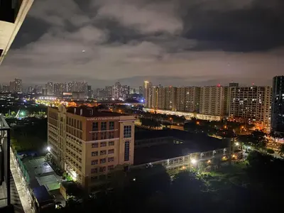 a view of a city at night with lights at HomeSuiteHome, Shore 3 Residences Moa Complex, Pasay City in Manila