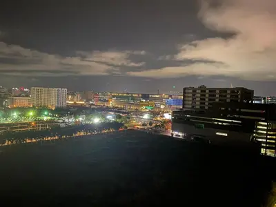 a view of a city at night with lights at HomeSuiteHome, Shore 3 Residences Moa Complex, Pasay City in Manila