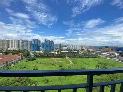 a view of a city from a balcony at HomeSuiteHome, Shore 3 Residences Moa Complex, Pasay City in Manila