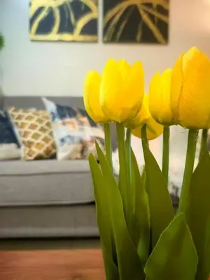a bunch of yellow tulips in a vase at Uptown BGC Spacious 1BR Unit by Terravista - Prague Suite in Manila