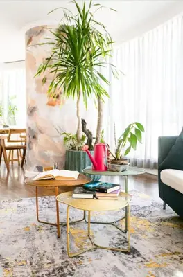 a living room with two tables and a plant at Glass House w Stunning View in Poblacion Makati in Manila