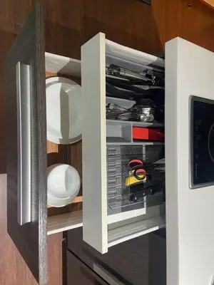 a cupboard filled with lots of kitchen utensils at 56th Floor -Sauna - Makati View - Knightsbridge Residences in Manila