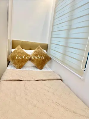 a bed with two pillows in a room with a window at La Casandrei in Dasmariñas