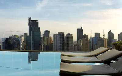 a pool with a view of a city skyline at D-Studio,Best Sunset Pool,Luxury,Hotel Style in Manila