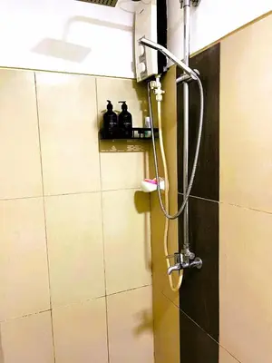 a shower in the corner of a bathroom at Chateau Staycation in Manila