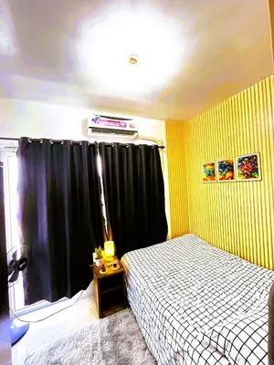 a bedroom with a bed and a black curtain at Chateau Staycation in Manila