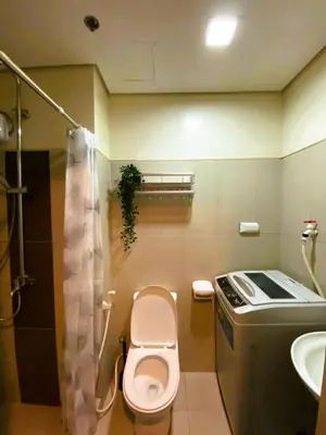 a small bathroom with a toilet and a sink at Chateau Staycation in Manila