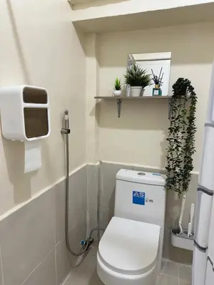 a bathroom with a toilet with plants on a shelf at Canlubang Transient house Asia 1 near 7-11 in Calamba