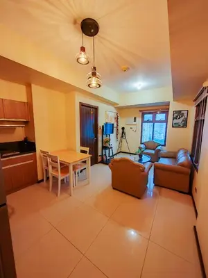a kitchen and a living room with a table at LeMoon's Chill with beautiful view-1 Bedroom in Manila