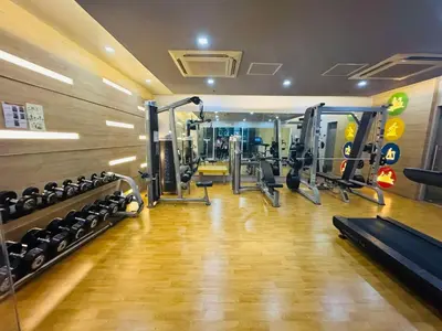 a gym with several treadmills and machines at Walking Distance Condo Across Naia T3 Airport in Manila