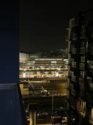 a view of a city at night from a building at Kyedenz Unit -Two Palm Tree Villas Newport Naia T3 in Manila