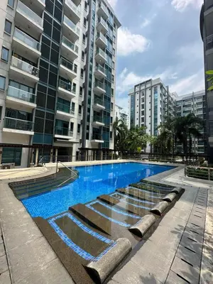 a swimming pool in a city with tall buildings at 5min Staycation Away from Naia Terminal 3 Airport in Manila