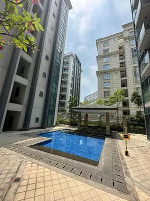 a swimming pool with a gazebo and buildings at Kyendenz Condotel-Across Naia T3 Pool View with Wifi in Manila